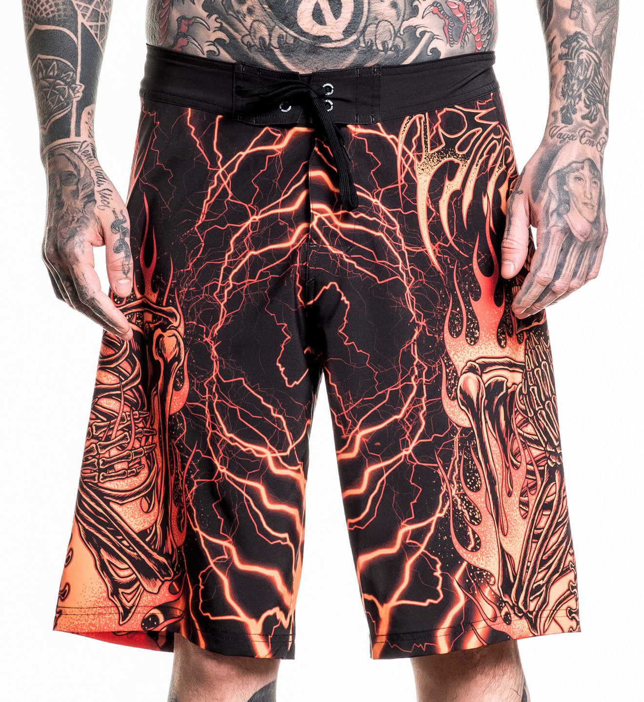 Infernal Nightmare Boardshort with fiery skeleton design, 92% polyester 8% spandex, model wearing size 32.