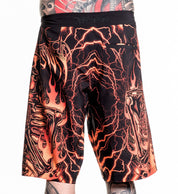 Infernal Nightmare Boardshort in black and orange with neon lightning and skeleton flame design, size 32 worn by model.