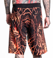 Infernal Nightmare Boardshort with fiery skeleton and lightning design, 92% polyester 8% spandex, model wearing size 32.
